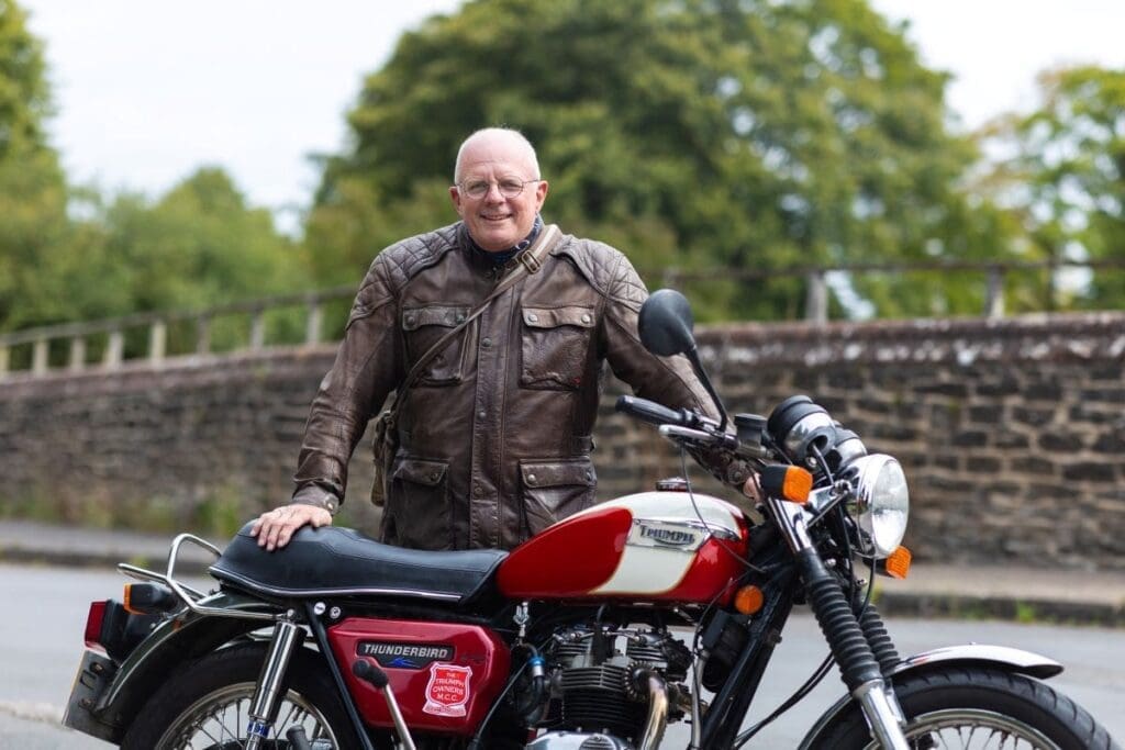 Owner Tim standing behind 1982 Triumph TR65 Thunderbird