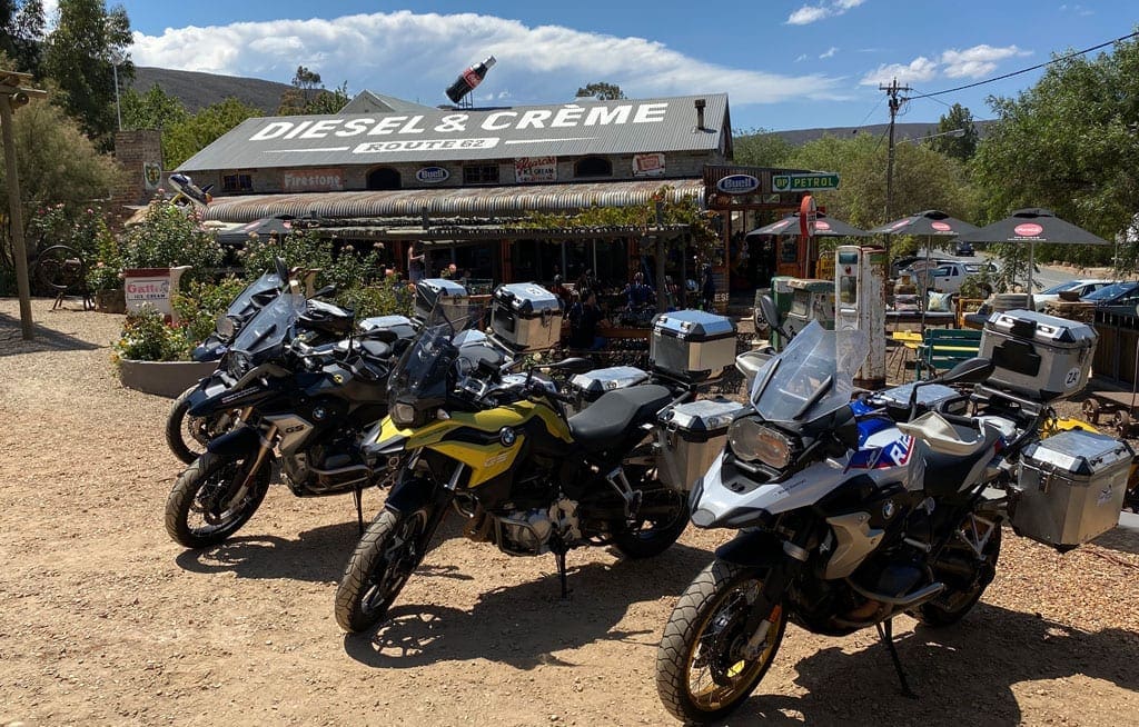The group's bikes parked up in a row outside a biker café.