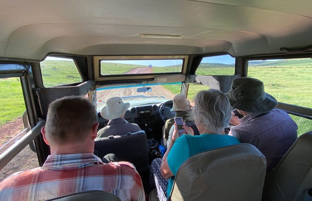 Elephant safari 3 The group sit inside the safari jeep as they travel along a road.