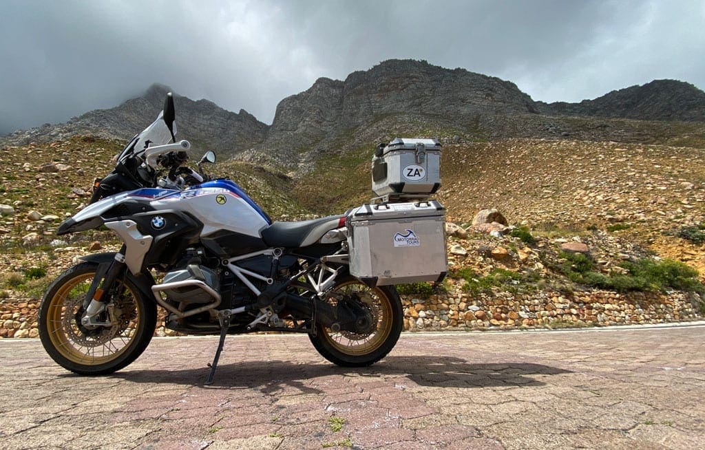 One of the bikes parked in front of a scenic view. 