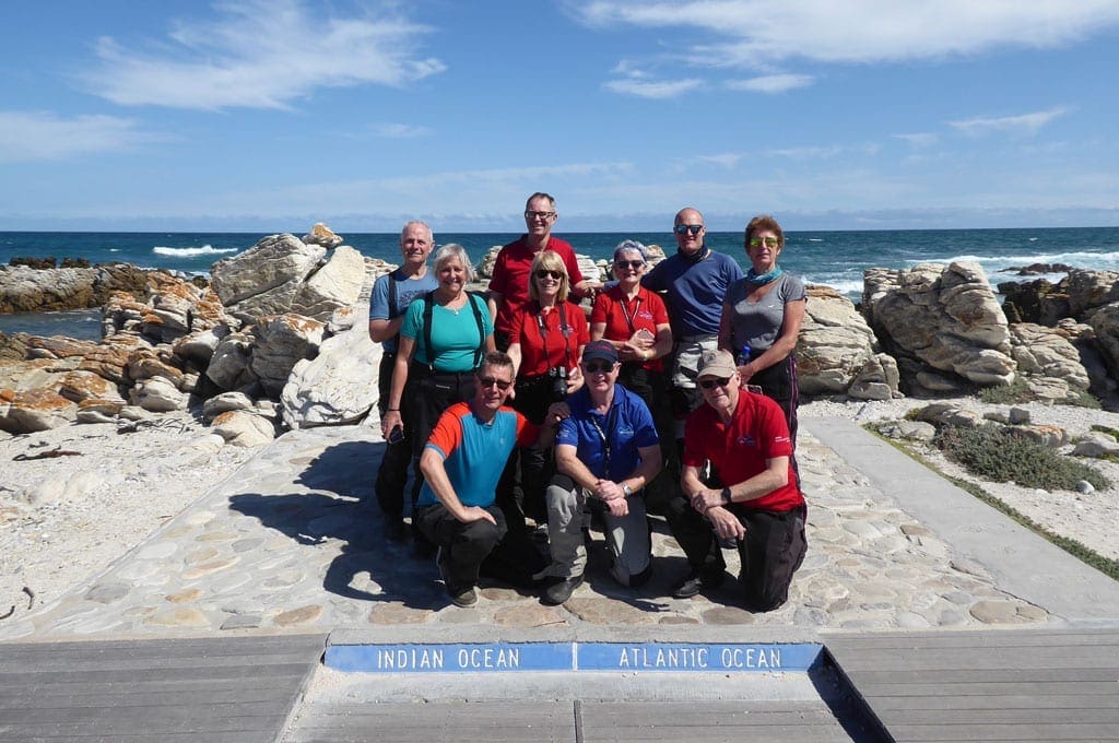 The group pose for a picture on the Indian and Atlantic ocean boarder.
