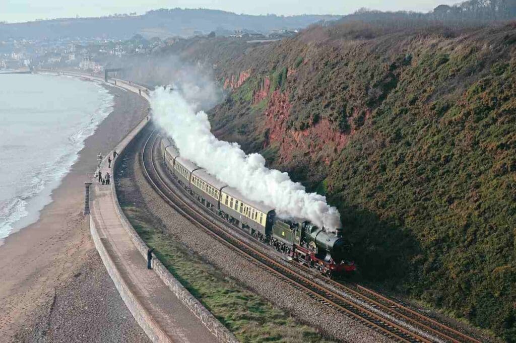 City of Truro rounds the curve at Langstone Rock as it approaches Dawlish Warren, Isambard Kingdom Brunel’s South Devon coastal route, while returning from Plymouth to Bristol Temple Meads with a Vintage Trains excursion on December 3, 2004. BRIAN SHARPE