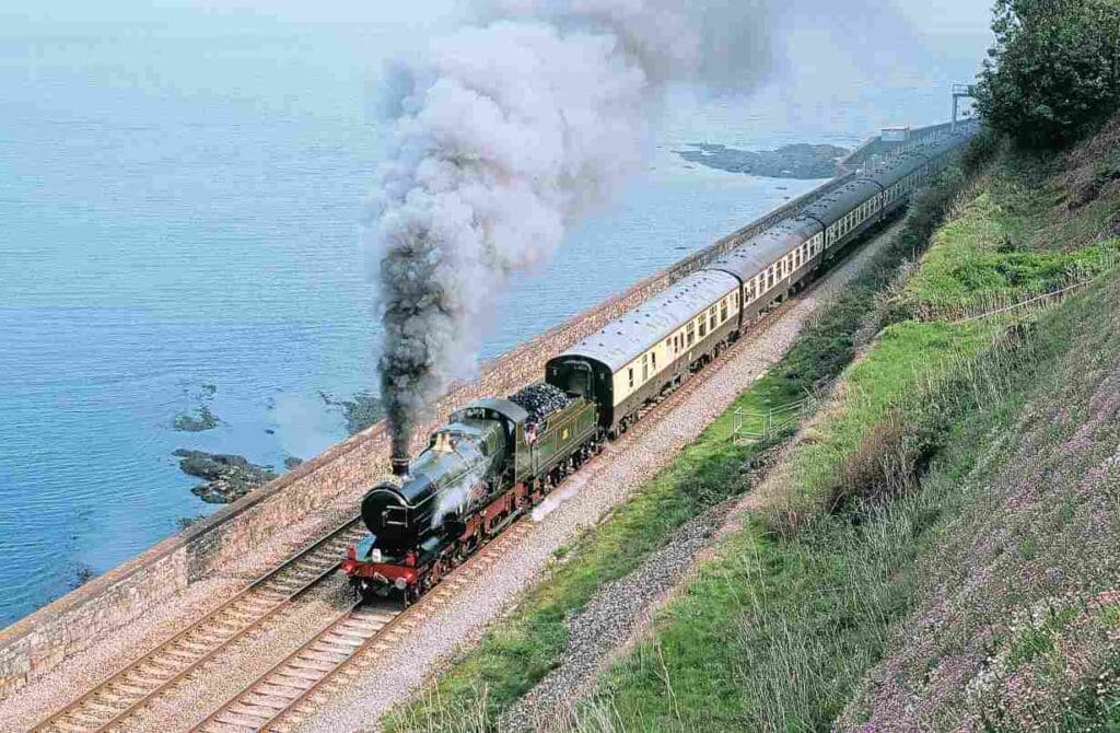 Celebrating the centenary of its legendary unofficial 102.3mph run, GWR 4-4-0 No. 3440 City of Truro accelerates away from a signal check at Horse Cove, between Teignmouth and Dawlish, on May 10, with the returning Pathfinder Tours’ ‘Ocean Mail 100’ tour from Kingswear to Bristol. BRIAN SHARPE