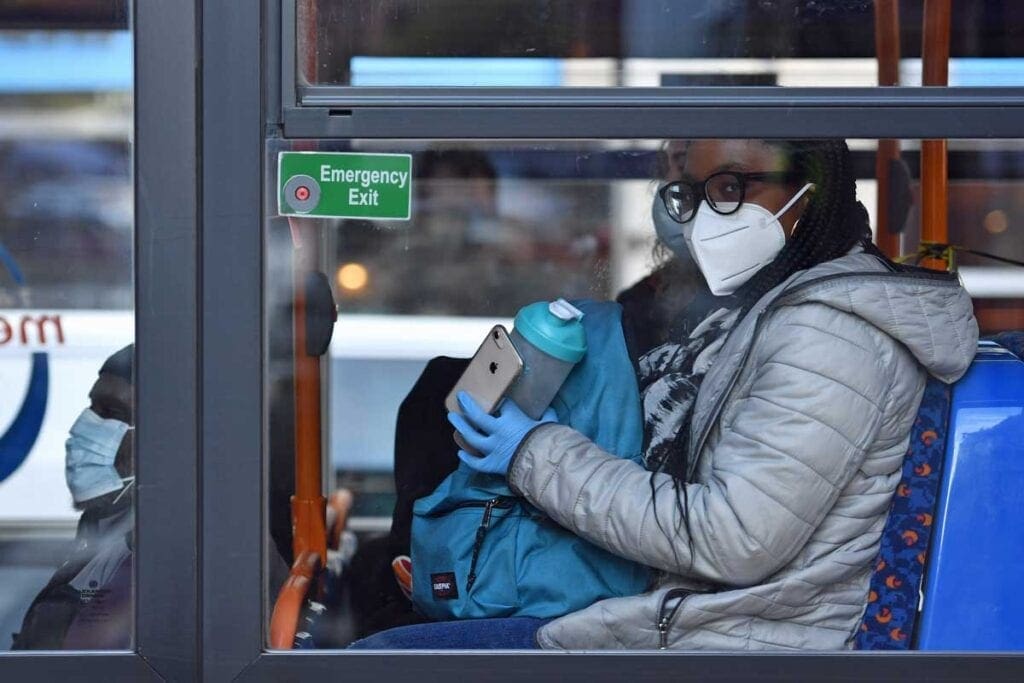 Woman wearing face covering on bus