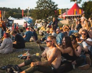 Crowds of people sat down in lines at a festival