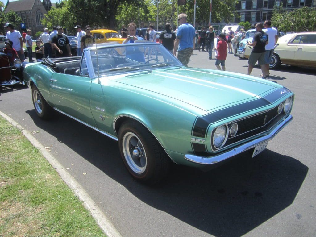 A turquoise Chevrolet Camaro convertible.