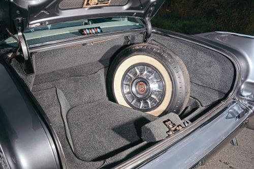 A spare tyre in the Sedan De Ville's carpeted boot.