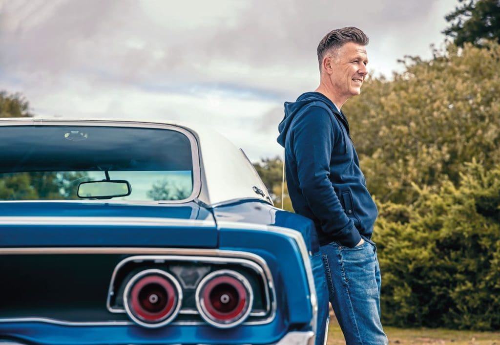 Owner Rob leans against his 1968 Dodge Charger