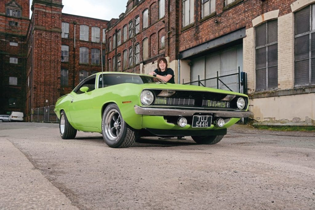 Tom leaning against his bright green 1970 Plymouth Barracuda