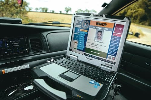 Close up of laptop open to a crime file as in American police cars.