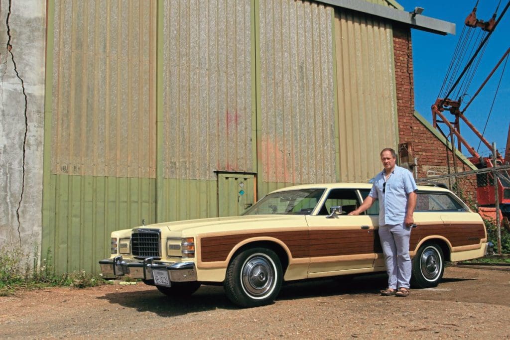 Darren Grimes stands beside his 1978 Ford Country Squire.