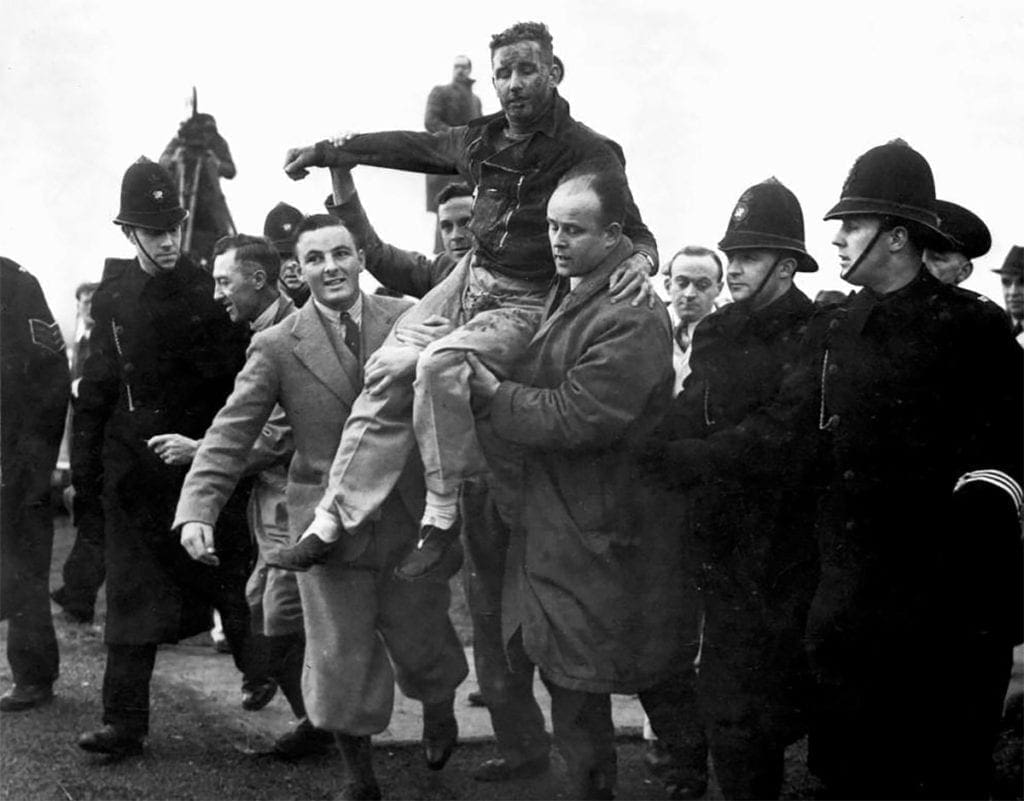 An exhausted Alex Henshaw is carried out of the cockpit of the Mew Gull after his epic flight to Cape Town and back in February 1939.