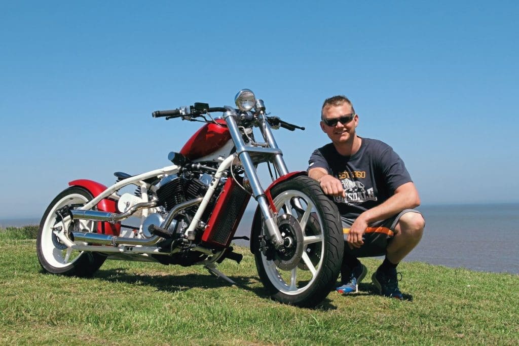 Glenn smiling next to the bike. 