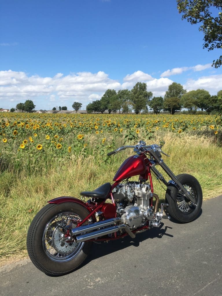 Sam's custom bike 1981 kZ1000J – Zelda parked in front of a field of sunflowers