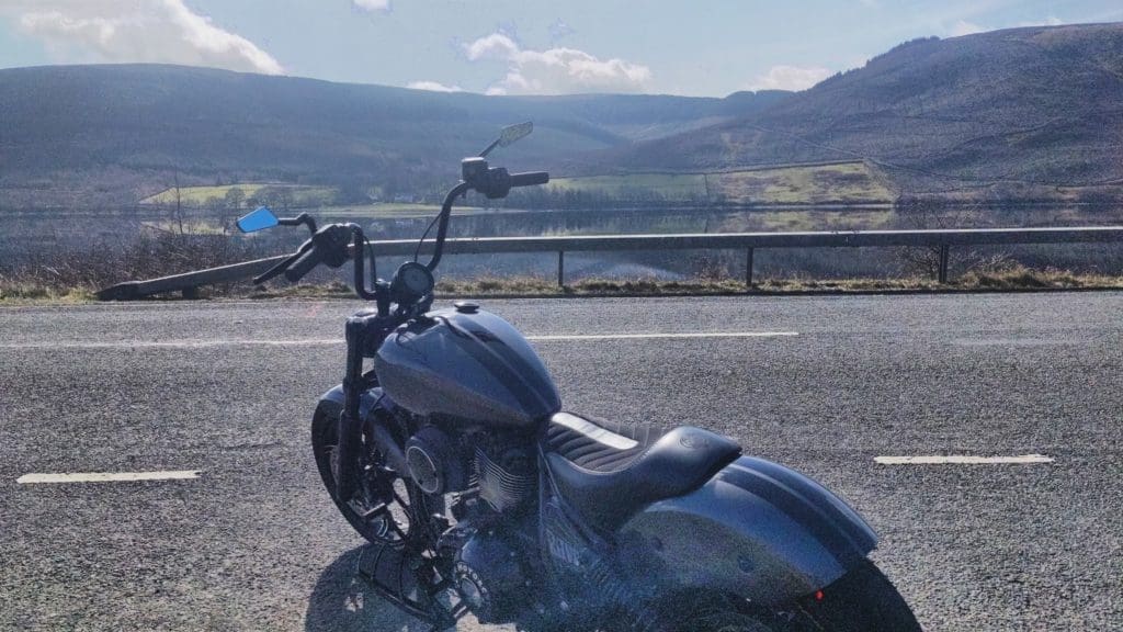 2022 Indian Chief Dark Horse - Raven parked in front of a hilly view