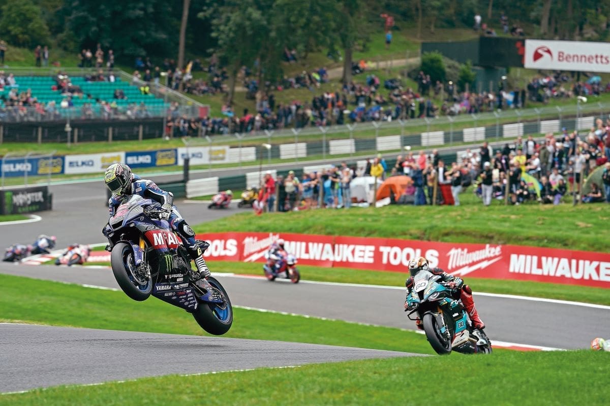 Jason racing, his bike lifting off the ground.