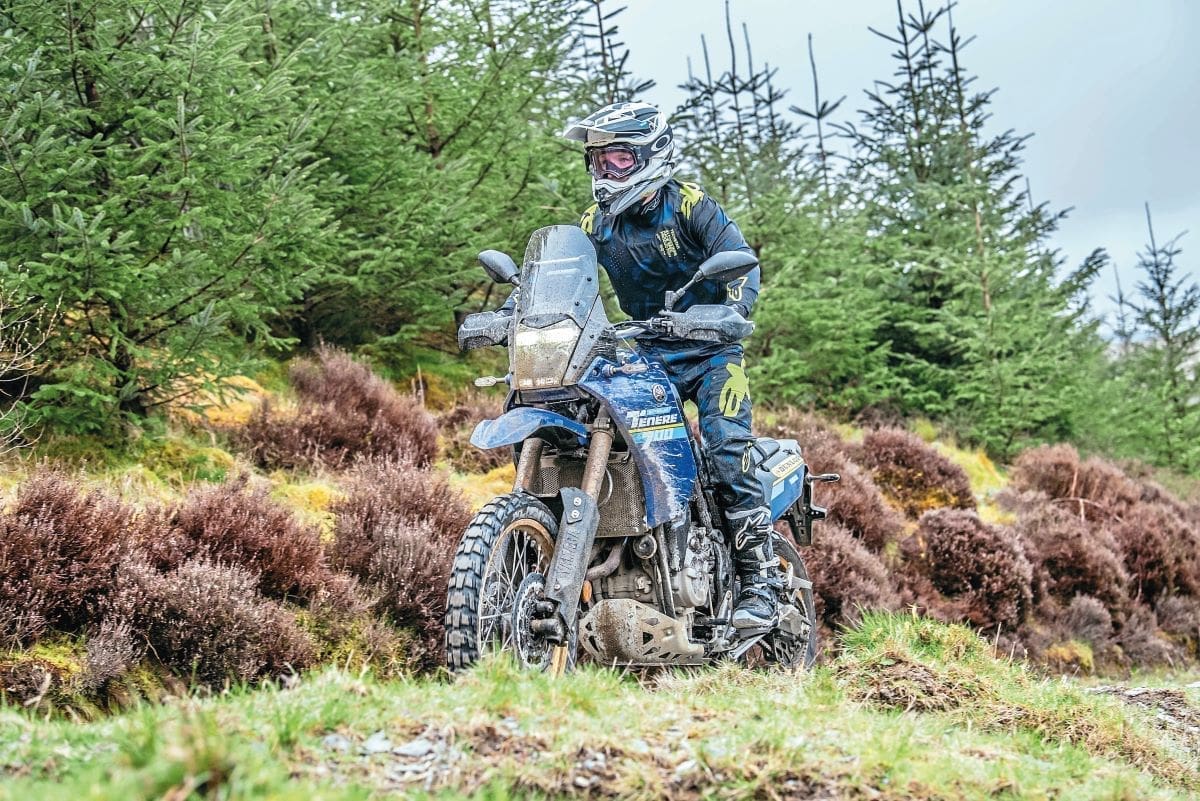 Tim on a mud-splattered blue Tenere 700 Extreme