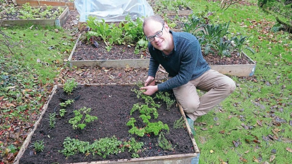 Ben tidying up his herb beds in his garden in March.