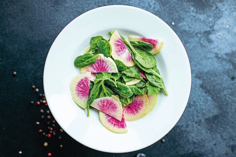 Watermelon radish and spinach on a plate