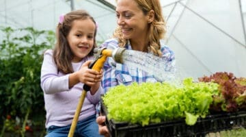 A mother and daughter growing vegetables together