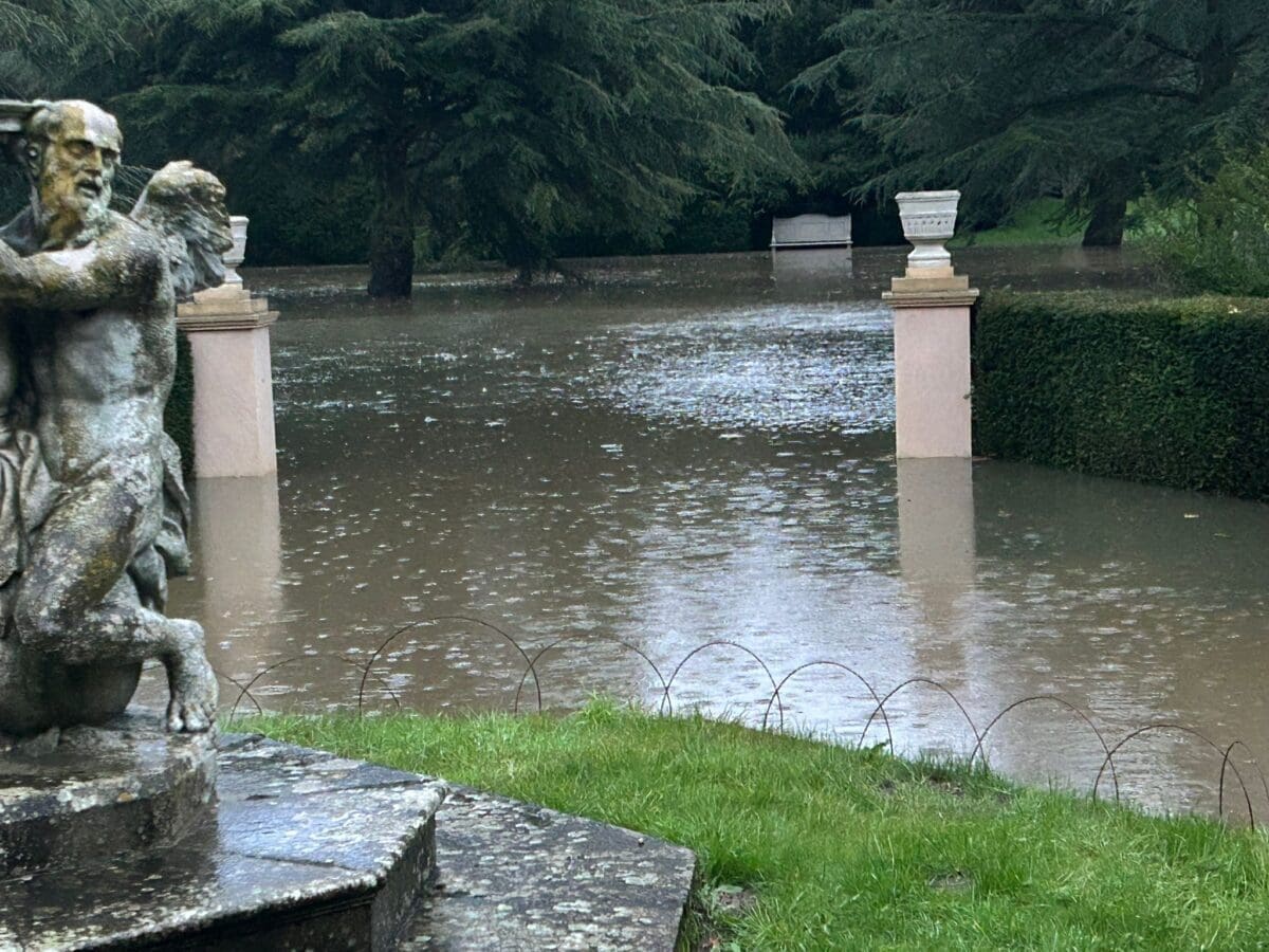 In the Dutch Garden at Belton, the Father Time sundial is encroached by water. (C) National Trust