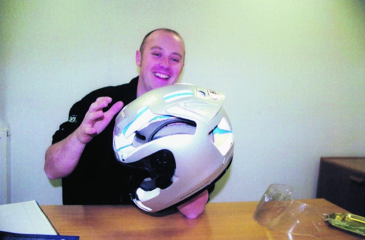 Using this cutaway Shoei X-Spirit, Rob shows the various parts that a crash helmet consists of, including the outer shell, EPS Iiner, visor, comfort padding, and the ventilation flow marked in blue.