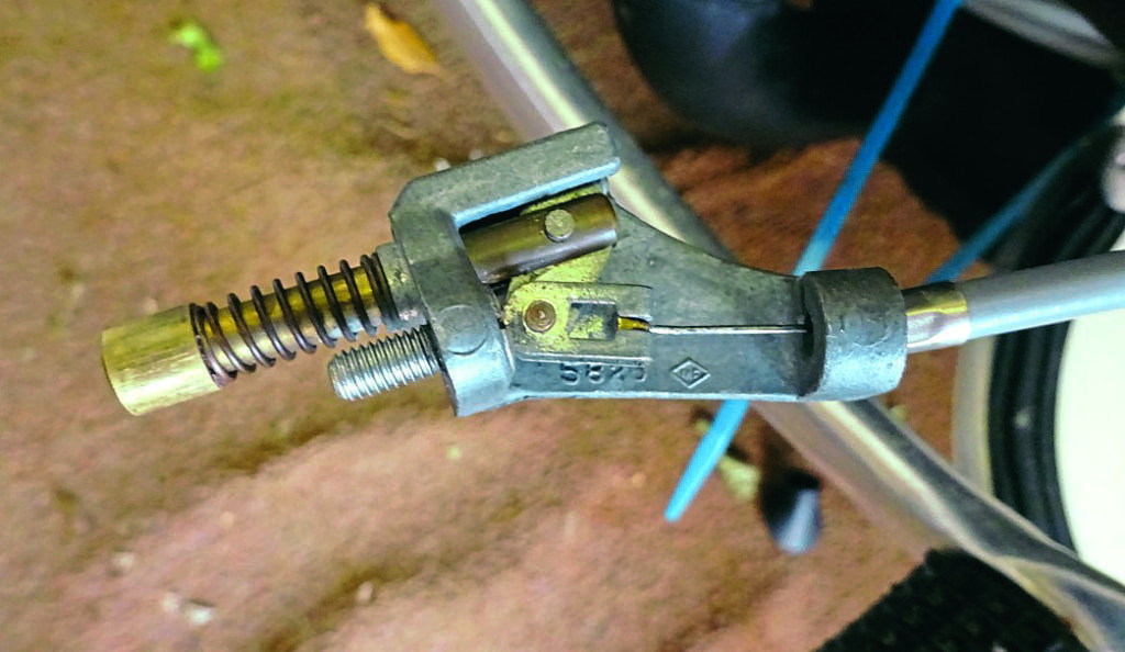 5: Now remove the choke mechanism from the carb and locate the outer choke cable into the end stop of this part. The inner cable/wire will now extend towards the sprung-loaded choke lever mechanism and can be hooked into place before the mechanism is once again refitted onto the carb. If the choke knob is now operated, it will return due to the pressure from the spring-loaded carb choke mechanism.