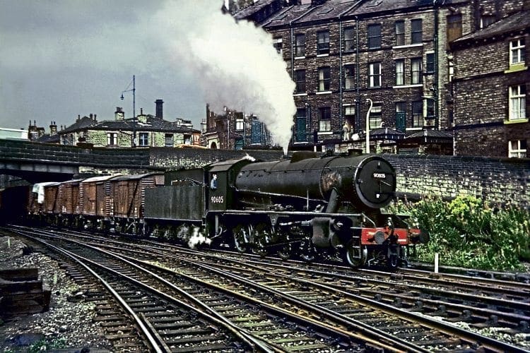 Royston-based WD Austerity 2-8-0 No. 90605, one of the last locomotives to be overhauled at Cowlairs, heads an eastbound freight into Shipley on August 31, 1966.  DAVE RODGERS