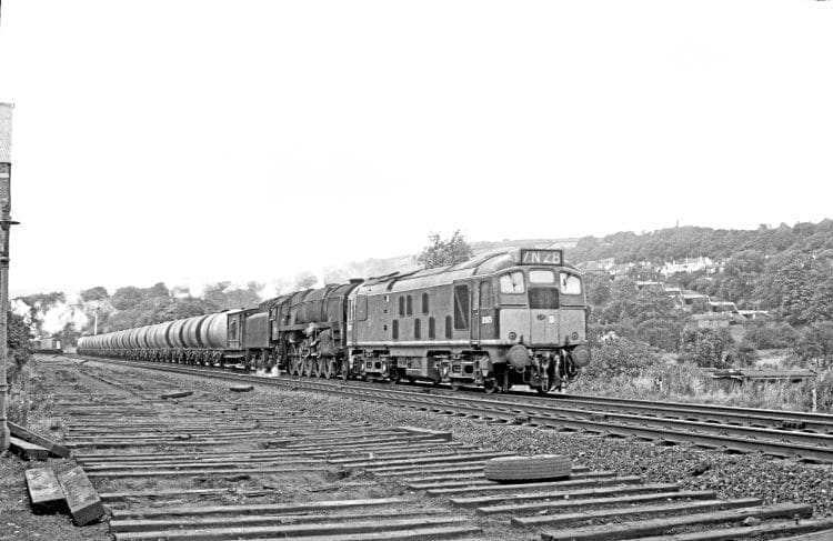 BR Sulzer Type 2 diesel D5075 and BR Standard 9F 2-10-0 No.  92118 approach Bingley with the Heysham-Neville Hill oil train on September 30, 1967. This combination of motive power continued to work this train after the end of steam in the West Riding. JOHN MARSH