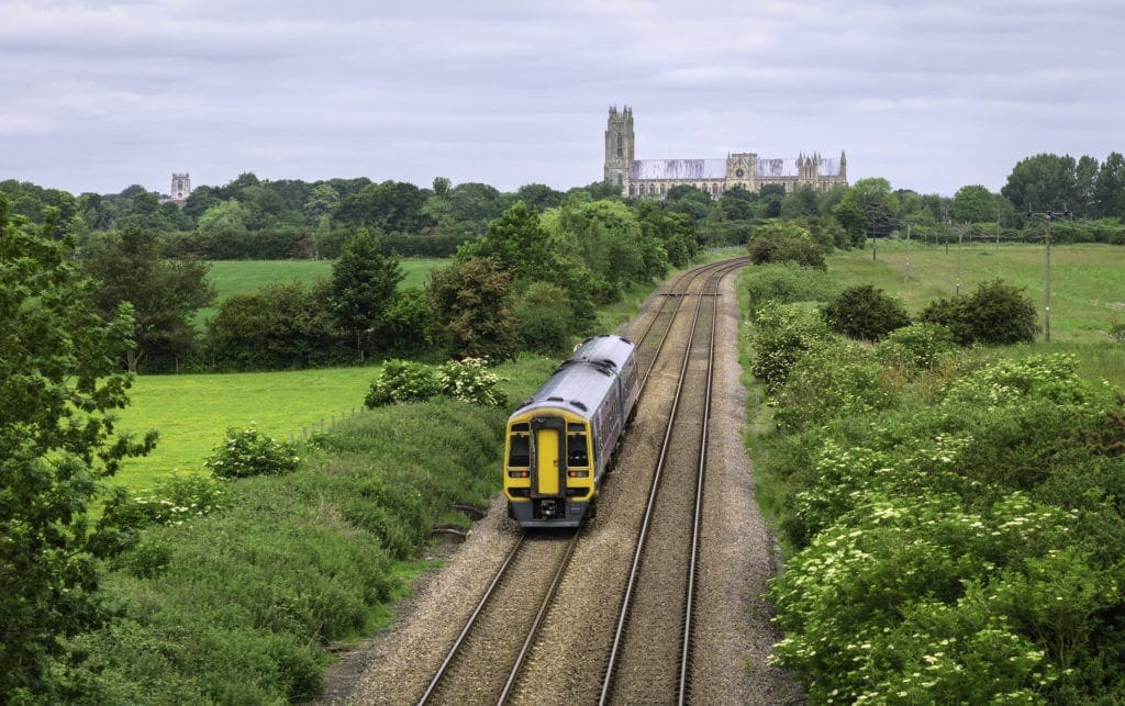Railway train in rural landscape with minster, Beverley, Yorkshire, UK.