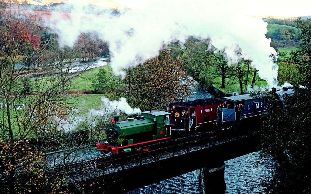 It was appropriate that the first steam locomotive to be purchased for the ELR, former North West Gas Board 0-4-0 No. 1, should be charged with hauling the
first works trains through to Rawtenstall on November 5, 1989. The locomotive is seen hauling a pair of brake vans and Austerity 0-6-0 No. 8 Sir Robert Peel assisting the train over Alderbottom No. 2 Bridge heading towards Rawtenstall with the second train of the day. Photo: Dave Dyson