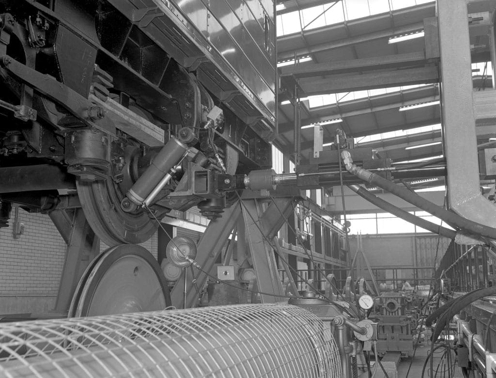 Underside of a train in a warehouse.