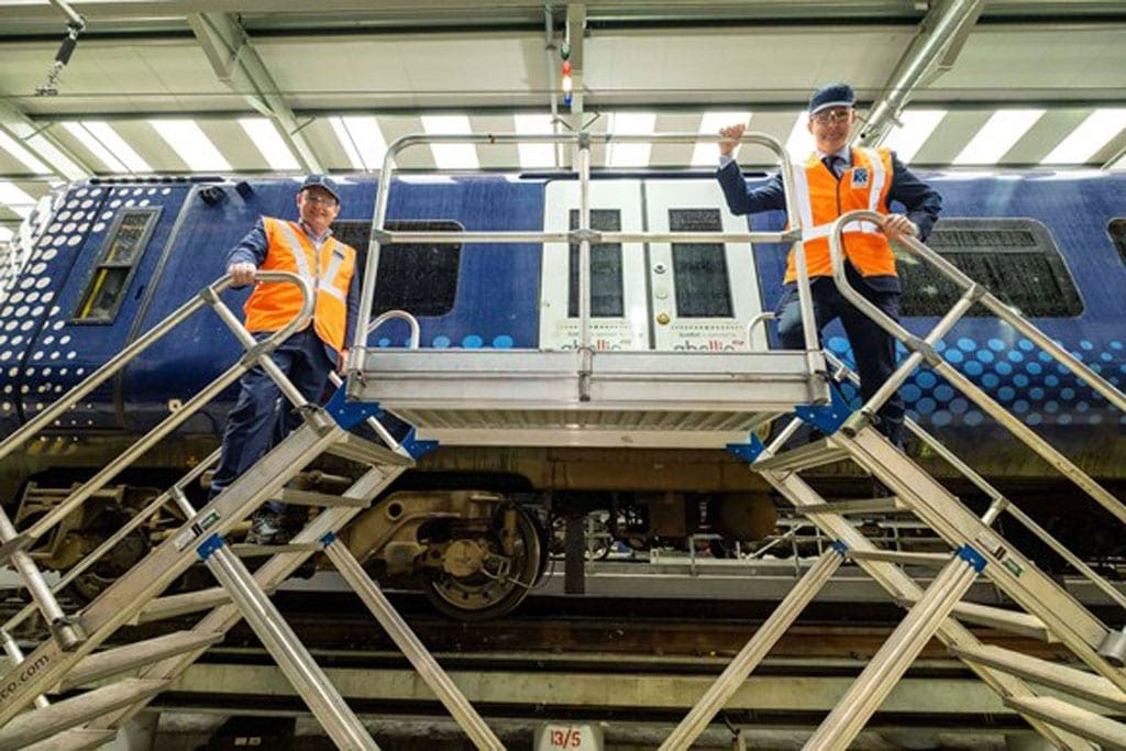 Rail workers in Scotland pose with Abellio carriage.