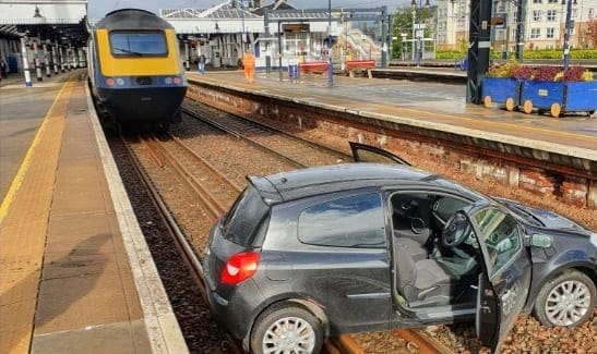 Car lands on train tracks at station in Scotland