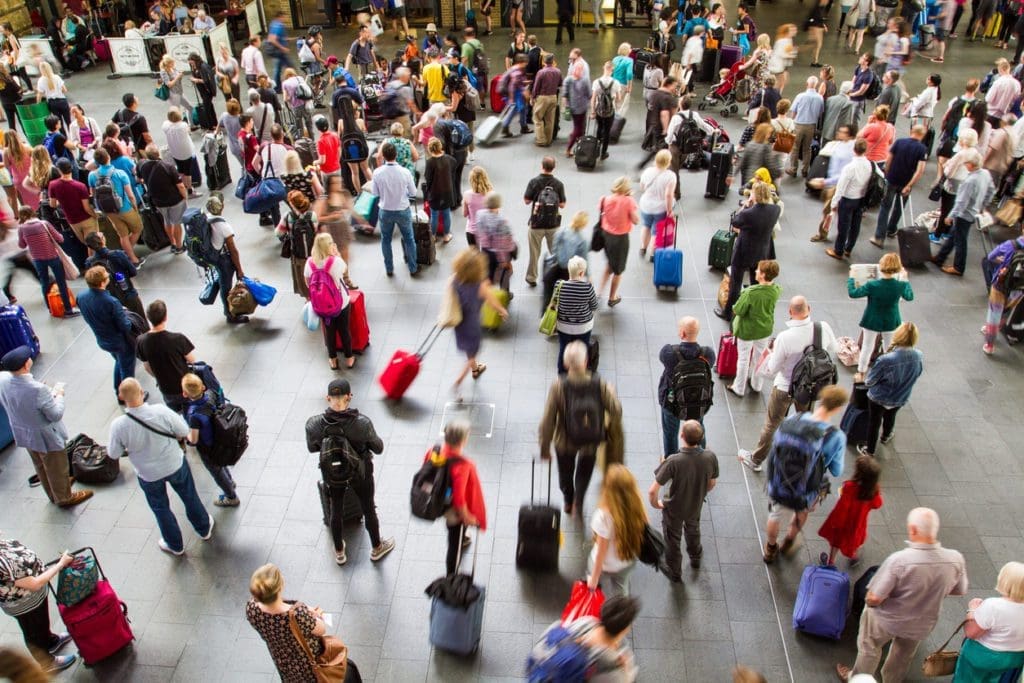 King's Cross Train Station, London, UK - July, 21, 2016.  An aerial view of King's Cross Train Station concourse in London, UK at rush hour or peak time and packed with waiting passengers, commuters and travellers waiting for information about their trains.