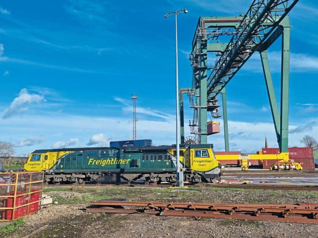 A blue sky at Freightliner’s Southampton Maritime Terminal with a train moving along the track