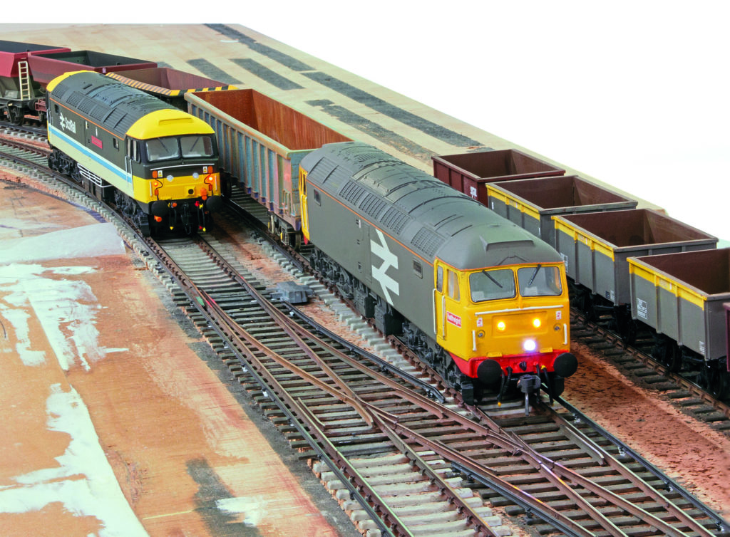 Model railway trains lined up on tracks