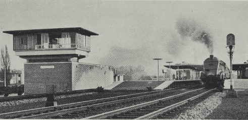 The down “Heart of Midlothian”, passing the new station and signalbox at Potters Bar. Local traffic uses the outside roads
