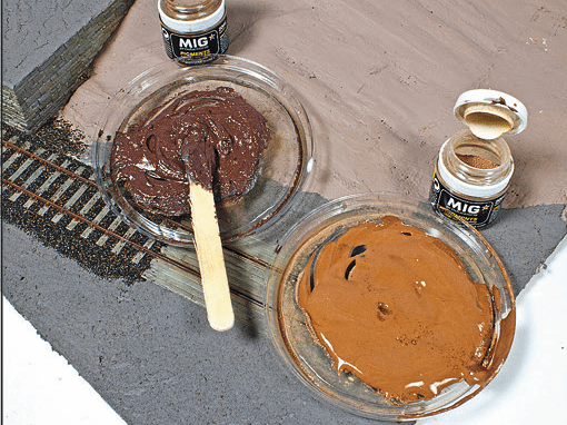 Practical skills can be fun, such as painting on a '00' diorama with paint and weathering powder.