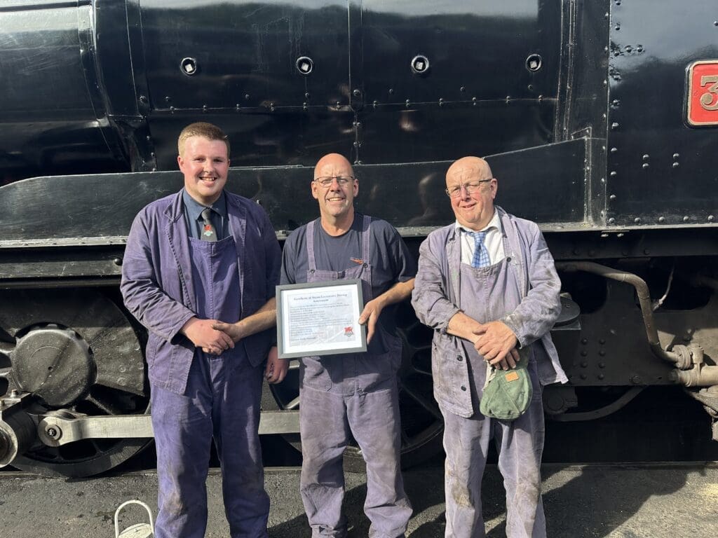 Tim Hines was presented with his certifcate by Andy Maxwell, pictured with fireman Steve Barker
