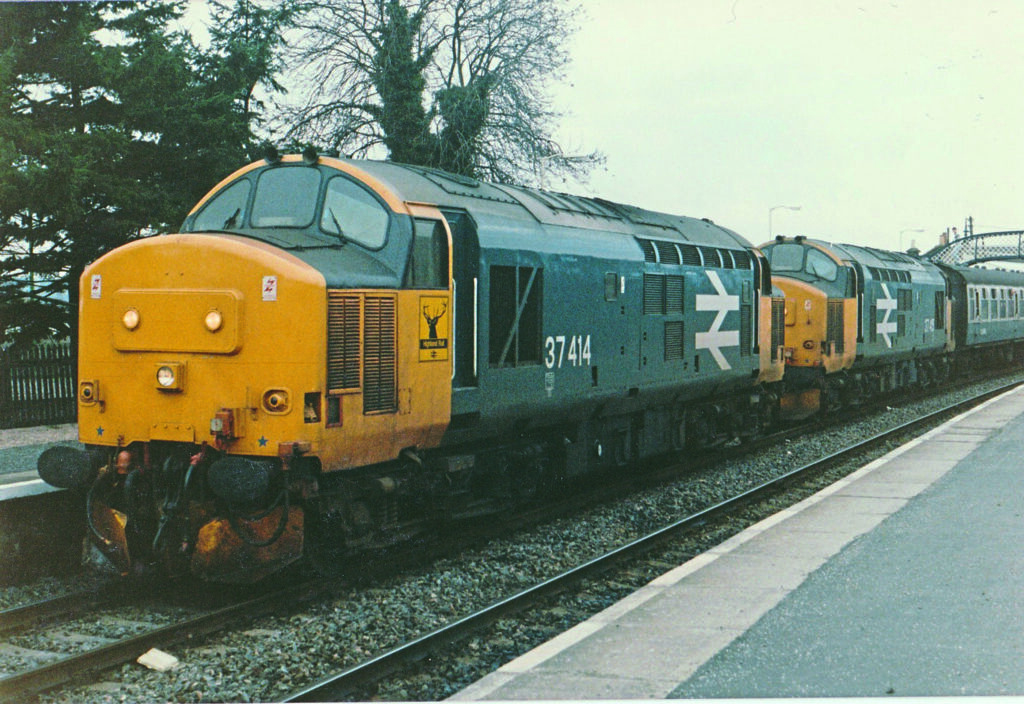 Having rescued 37415 at Alness, 37414 removes the failed loco at Tain beforecontinuing north with the now heavily delayed 2H63, the 11.35 Inverness-Wick, onFebruary 17, 1986. Gareth Dunn