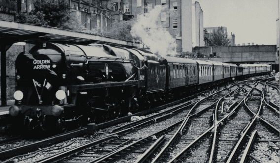 Clan Line’ and the ‘Golden Arrow’ 1996-style. The rebuilt No. 35028 drifts quietly into London Victoria station with the up Pullman on the evening of April 27, 1996. The Union Jack, Tricolour, headboard and coaches provide a common thread. K.J.C. Jackson.