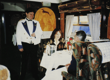 The opulence and splendour which characterises Pullman travel is seen to good effect as the authoress dines with VSOE official Martin Newnham-Darling on April 14, 1996. Steward Michael Legg looks on. Robert Birch.