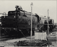 No. 35028 is not allowed onto the pier at Portsmouth Harbour, so on southbound runs comes off the train at Fratton. (This arrangement is not necessary on up services as the engine can stand on solid land at the London end of the station.) During the turn-round time on March 3, 1996, the Pacific is serviced on non-electrical sidings at Fratton depot. K.J.C. Jackson.