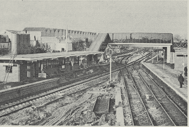 View looking north of Bedford Station: (left) new island platform still under construction in December; (centre bottom) demolished old down platform; and (right) now-redundant up platform with (beyond) new third platform, which should be completed next year, and resited station buildings opened last October. Local tracks here are being realigned through an angle of approximately 30 deg.