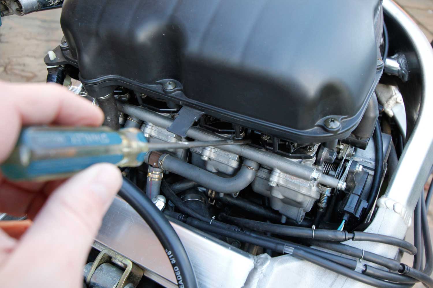 8 Remember that the fourth throttle body is your reference point, so with a long screwdriver, carefully adjust the screw between the third and fourth throttle bodies to get the third vacuum gauge as close as possible to the fourth. Ignore whatever happens to the first and second gauges. Try to put as little pressure as possible on the screwdriver as you make any adjustments, and always take it away from the screw, and ‘blip’ the throttle before taking your reading.