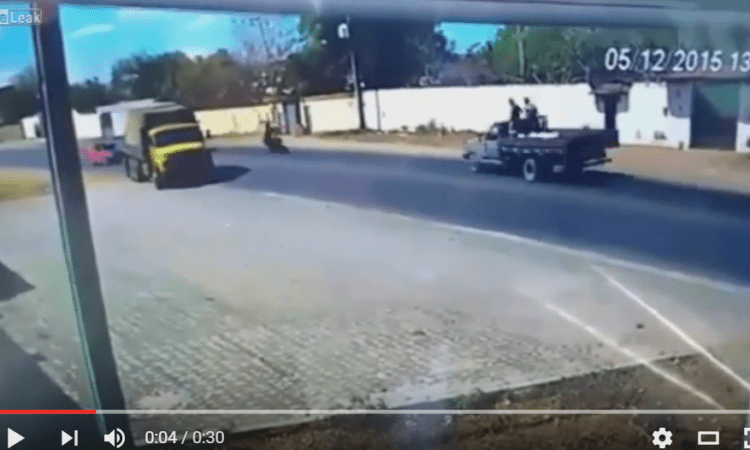 Video: biker misses truck by inches – but bike gets mashed in head-on crash!