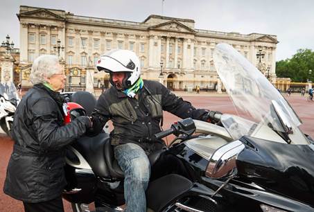 ‘The Queen’ thanks her Carole Nash biker for her ride to work Photo credit: Carole Nash
