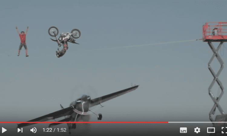 Video: Backflip over a plane? Whilst it flies under a high-wire act? Easy! Gulp…