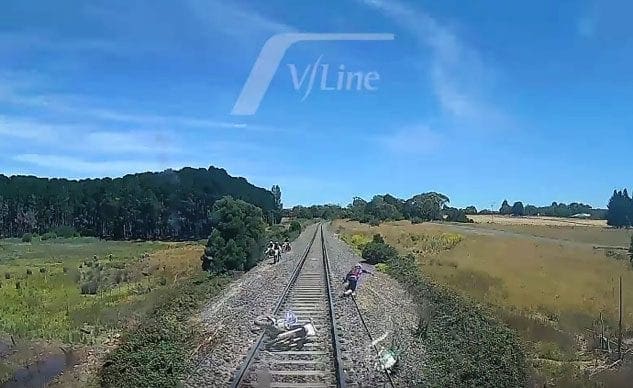 Video: Adventure rider has to leap for his life when he falls off in front of a speeding train!